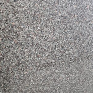 Close-up texture of Apple Green Polished Granite showing fine-grain mineral blend of green, black, grey, and brown tones, reflecting true natural stone quality and polished smooth finish.